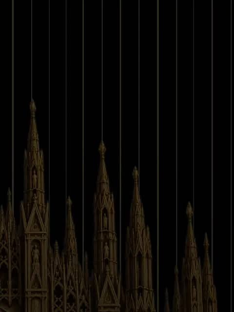 Gold Duomo di Milano spires against black pinstripes